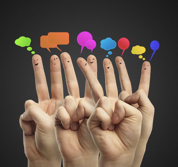 گروه شاد شکلک های انگشتی با علامت چت اجتماعی و حباب های گفتار انگشتان نشان دهنده یک شبکه اجتماعی