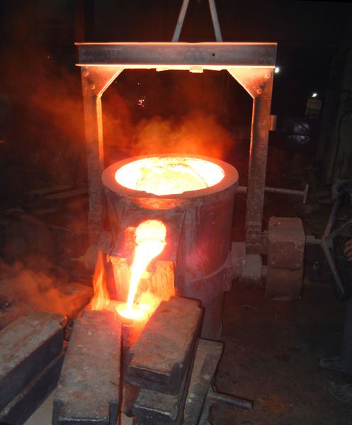 ریختن فلز مایع صنعت آهن و فولاد ریخته گری - فلز مذاب که از ملاقه ریخته می شود