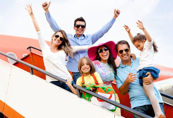 خانواده هیجان زده با دستان بالا در حال سفر با هواپیما