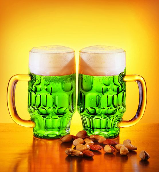 آبجو سبز ایرلندی الکل سنتی برای جشن تعطیلات روز سنت پاتریک نوشیدنی شبدر خوش شانس دو لیوان با آجیل غذا و نوشیدنی طبیعت بی جان