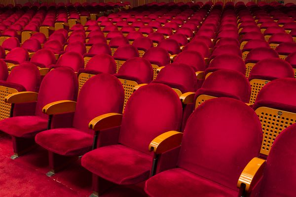 صندلی های قرمز خالی برای سینما تئاتر کنفرانس یا کنسرت