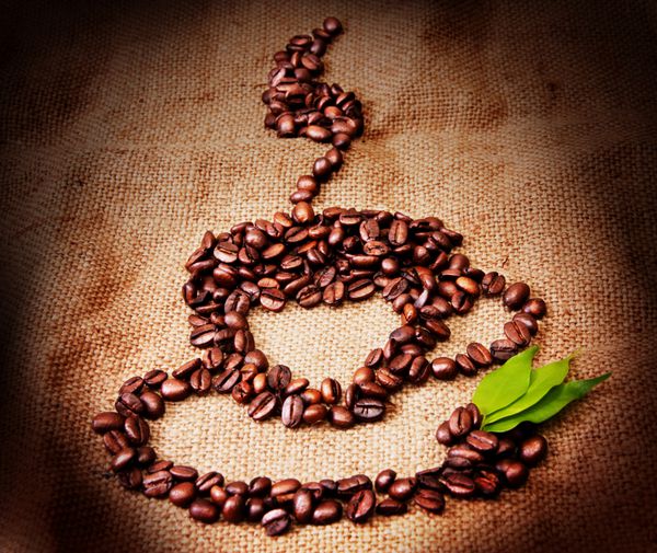 فنجان قهوه از دانه های قهوه گذاشته شده است