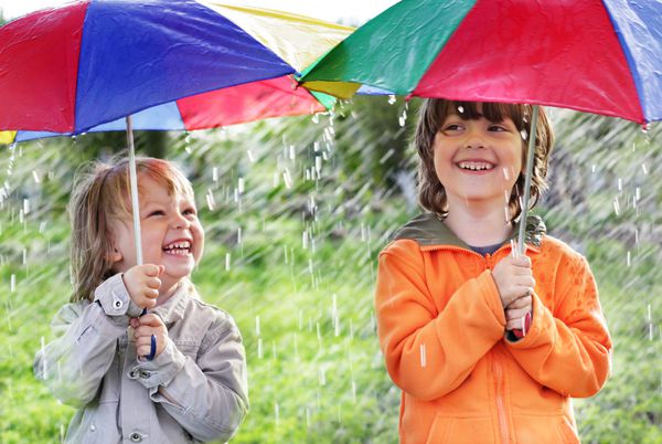 دو برادر شاد با چتر در فضای باز
