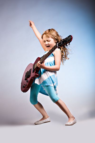 پرتره دختر جوان با گیتار روی صحنه