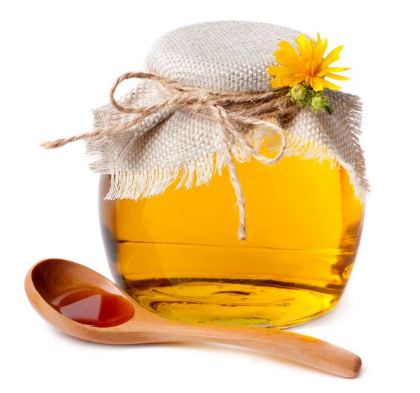 عسل در قابلمه و یک قاشق چوبی