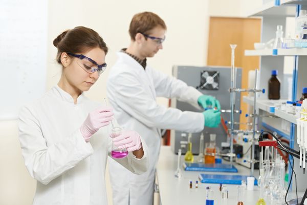 دو محقق زن و مرد در آزمایشگاه شیمی تحقیقات علمی