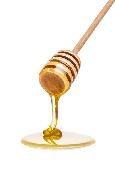 قطره عسل جدا شده در پس زمینه سفید