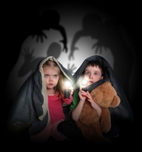 دو کودک کوچک زیر یک پتو پنهان شده اند و با چراغ قوه به ارواح هیولای ترسناک سیاه رنگ در پس زمینه نگاه می کنند