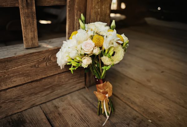 دسته گل عروسی زیبا با کمان و قلب روی موج سواری چوبی