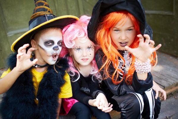 پرتره سه دختر هالووین که با ژست های ترسناک به دوربین نگاه می کنند