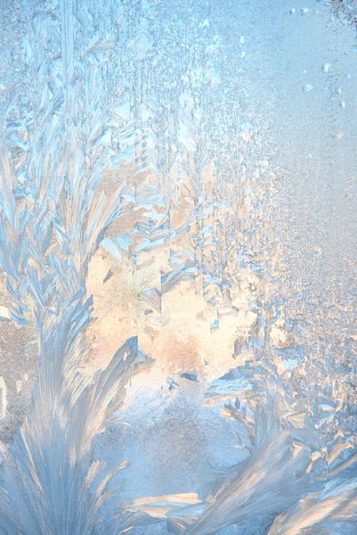 الگوی یخ زده در شیشه پنجره زمستانی