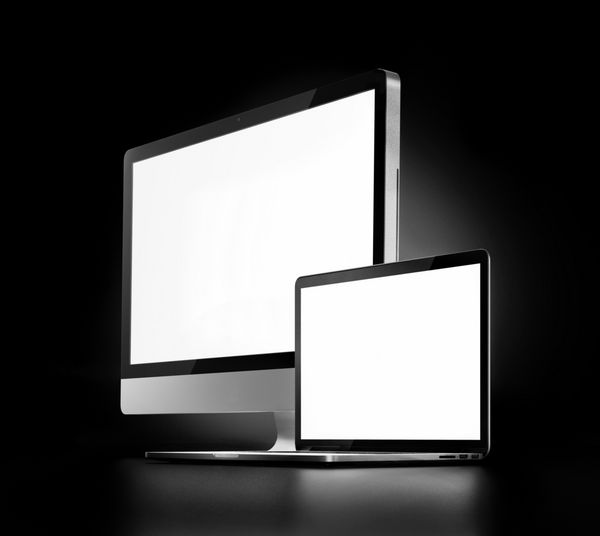 دو کامپیوتر با صفحه نمایش سفید در پس زمینه تیره