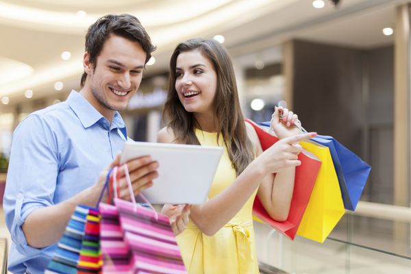 زوج شادی که در هنگام خرید از تبلت دیجیتال استفاده می کنند