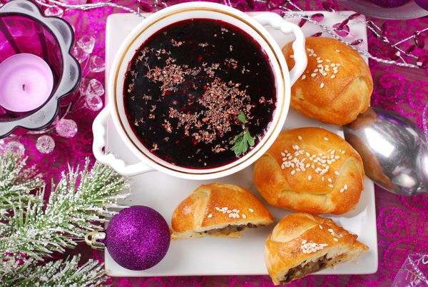 فنجان گل گاوزبان قرمز سنتی و شیرینی خمیر مایه با قارچ برای نمای بالای شب کریسمس