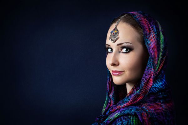 پرتره زن زیبا با تیکای هندی که در روسری پیچیده شده است