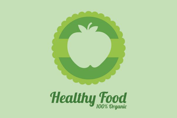 تصاویر غذای سالم برچسب دایره ای با سیب روی پس زمینه سبز رنگ