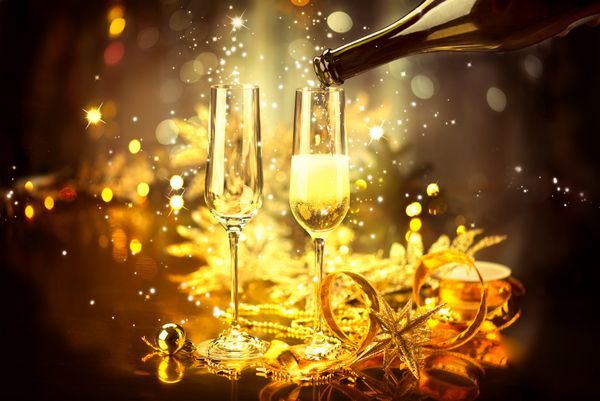 جشن سال نو با شامپاین شامپاین کریسمس و جشن سال نو میز تزئین شده در تعطیلات سال نو دو لیوان شامپاین