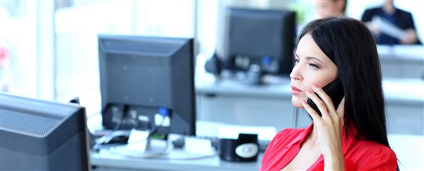 مفهوم کسب و کار - تاجر زن در حال صحبت با تلفن در دفتر