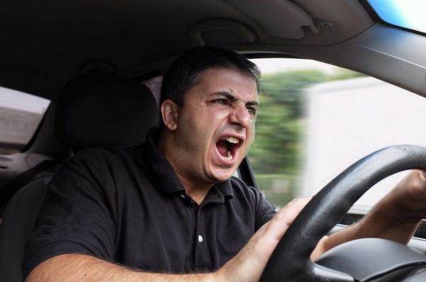 مرد عصبانی که بدون کمربند ایمنی رانندگی می کند
