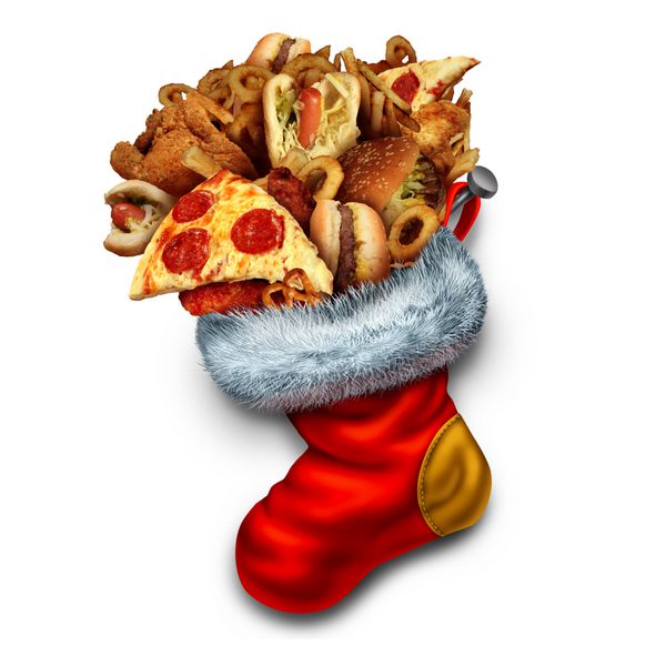نماد غذا خوردن ناسالم تعطیلات به عنوان گروهی از فست فودهای چرب مانند سگ های همبرگر و مرغ سوخاری پر شده در جوراب قرمز کریسمس به عنوان نمادی برای چاقی و پرخوری در تعطیلات زمستانی