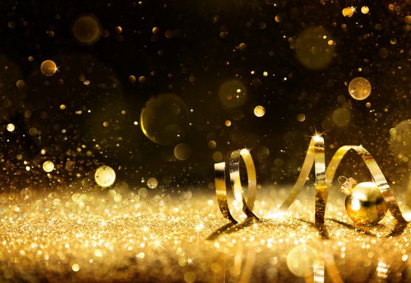 استریمرهای طلایی با زرق و برق درخشان - پس زمینه تعطیلات کریسمس