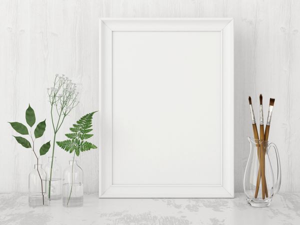 ماکت پوستر داخلی عمودی با قاب خالی برس های هنری و گیاهان در بطری در پس زمینه دیوار سفید رندر سه بعدی
