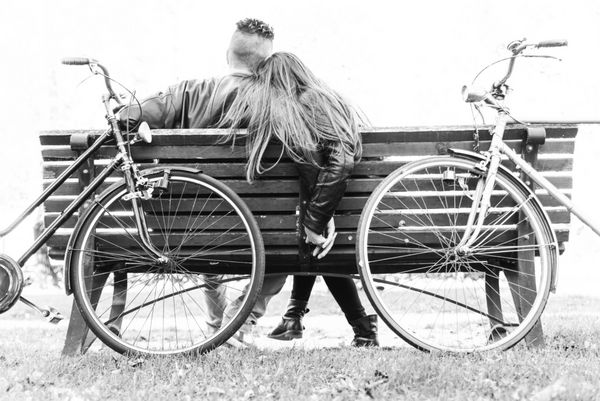 زوج روی نیمکت - دو عاشق که روی یک نیمکت در یک پارک نشسته اند و خود را با دست گرفته اند - مفاهیم پاییز عشق با هم بودن رابطه