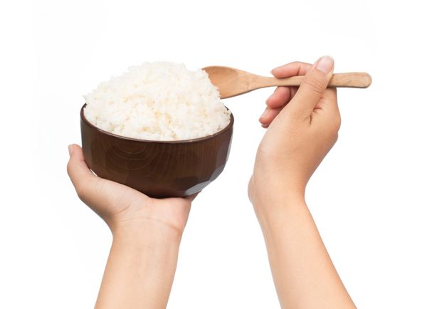 کاسه برنج دستی با قاشق جدا شده در پس زمینه سفید