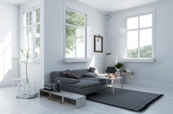 گوشه ای دنج در یک اتاق نشیمن سفید شیک با کاناپه و فرش خاکستری روکش راحت در فضای داخلی روشن روشن با پنجره ها رندر سه بعدی