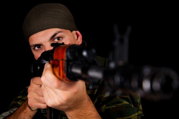 سرباز با یونیفرم با تفنگ تمرکز انتخابی روی f