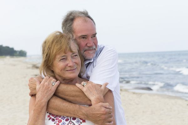 یک زوج مسن در ساحل در حال بغل کردن