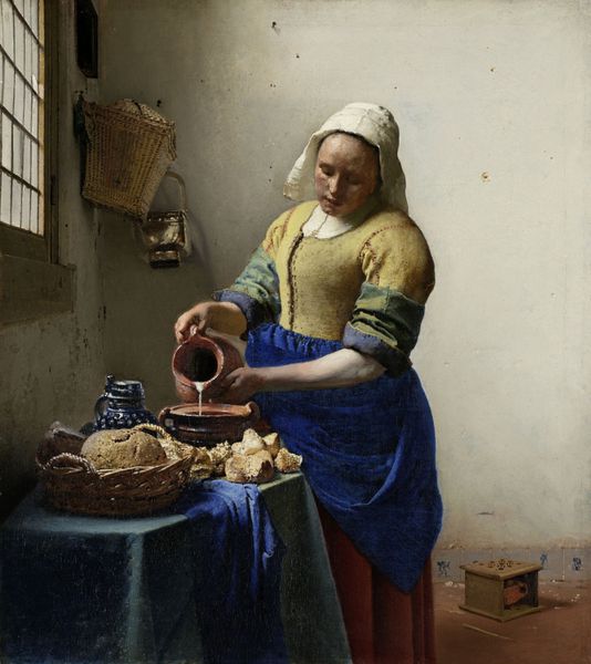 خدمتکار شیر اثر یوهانس ورمر 1660 نقاشی هلندی رنگ روغن روی بوم زن جوانی که با نور پنجره روشن می شود شیر را در دیگ پخت و پز کنار سبد حصیری نان می ریزد در سمت راست پایین