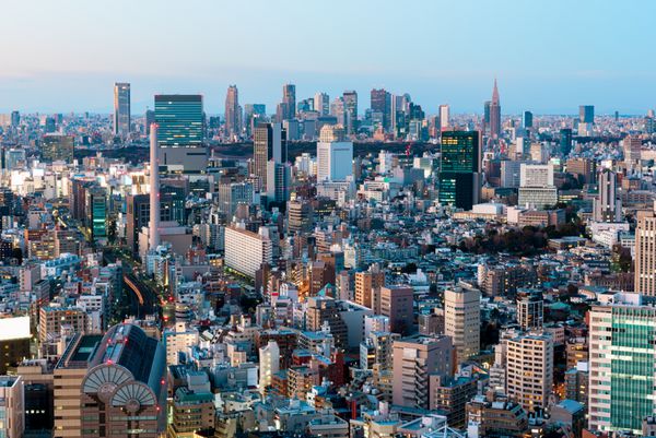 خط افق توکیو در گرگ و میش ساختمان های مرتفع بخش شینجوکو در دوردست قابل مشاهده است