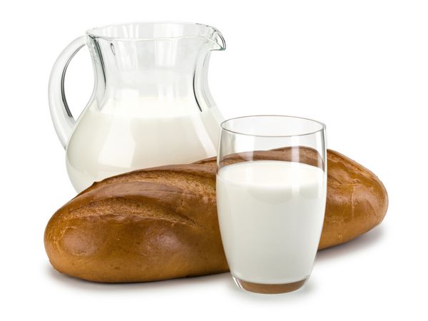 ظروف شیشه ای پر از شیر و یک نان بلند سفید