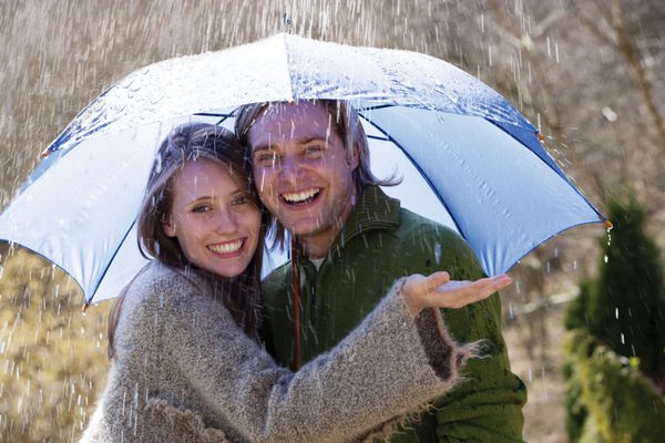 زوج جوان در حال خوشگذرانی زیر باران