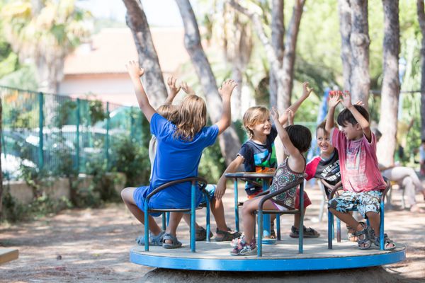 Bambini sorridenti su una giostra al parco giochi