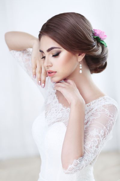 پرتره عروس سبزه زیبا آرایش و مدل موی روشن در لباس توری