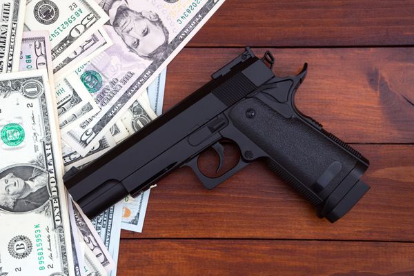 تفنگ سیاه در پس زمینه پول