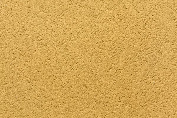 دیوار گچی رنگ اخرایی زرد بافت پس زمینه