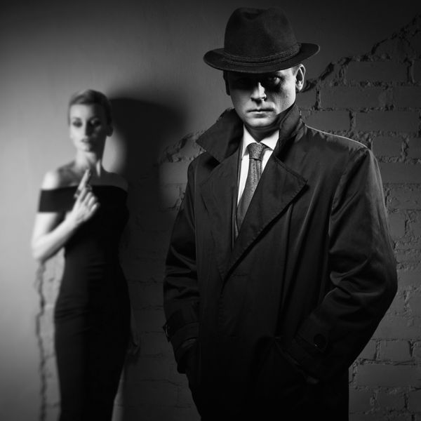 فیلم noir مرد کارآگاه در باران و کلاه و یک زن خطرناک با تفنگ در دست خود