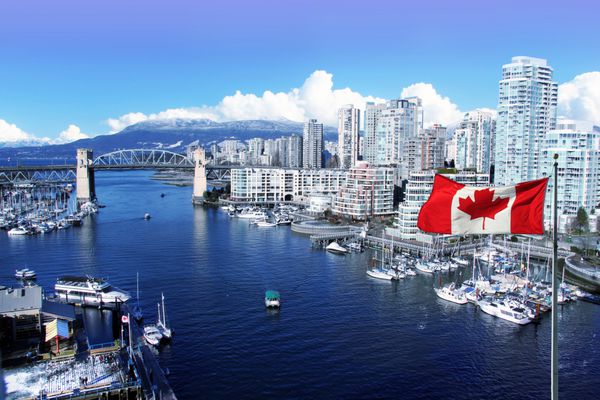 پرچم کانادا در مقابل دیدگاه False Creek و پل خیابان برادارد در ونکوور کانادا