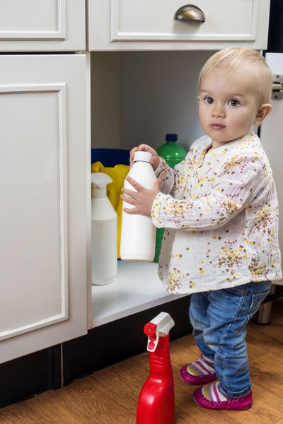 کودک کوچک با تمیز کردن محصولات در خانه