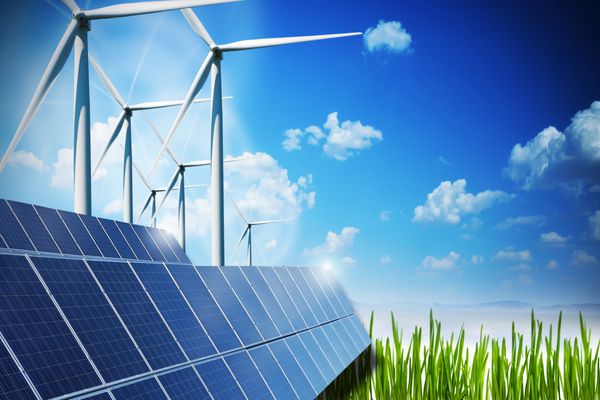 مفهوم انرژی تجدید پذیر با پانل های خورشیدی و توربین های بادی در زمینه سبز