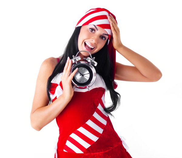 زن جوان شوکه شده با یک ساعت زنگ دار به عنوان سانتا لباس پوشید