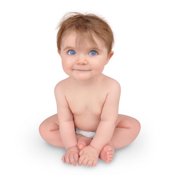 A cute little baby is sitting on a white isolated background with big blue eyes The child