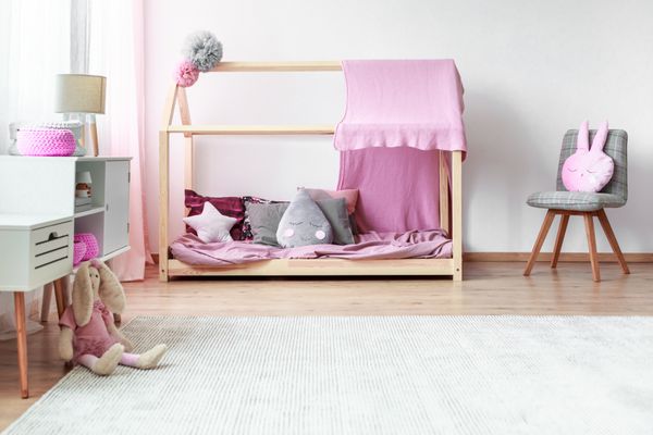 Plush toy on white carpet in grey and pink girl