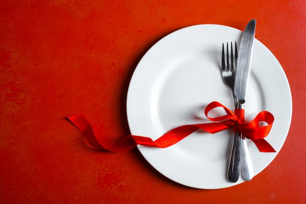 Festive table setting on a red background Concept Valentine
