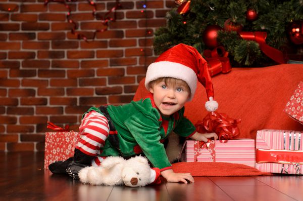 پسر کوچک در صحنه و لباس در کریسمس داخلی