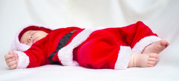 کودک ناز در قرمز و سفید کریسمس سانتا کت و شلوار