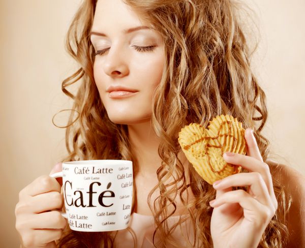 زن خوردن کوکی و نوشیدن قهوه زیبا دختر شایان ستایش زن جوان زیبا